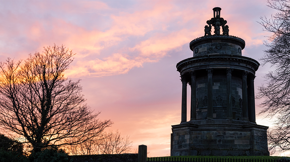 The Burns Monument in Edinburgh in Scotland, the United Kingdom at sunset